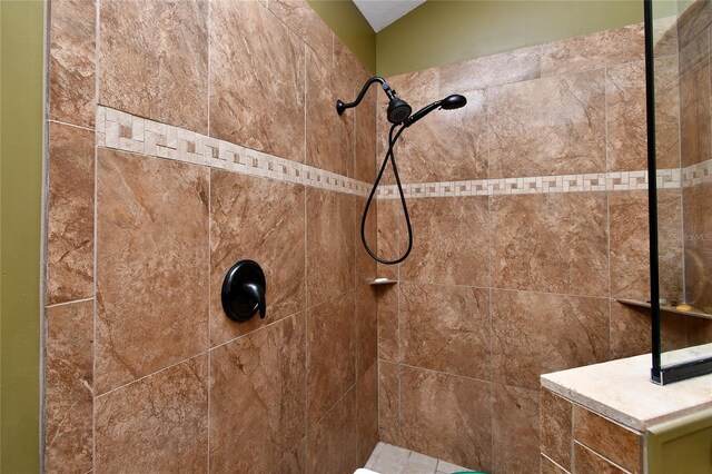 bathroom with a tile shower