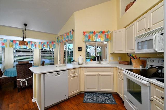 kitchen with pendant lighting, sink, white appliances, dark wood-type flooring, and kitchen peninsula