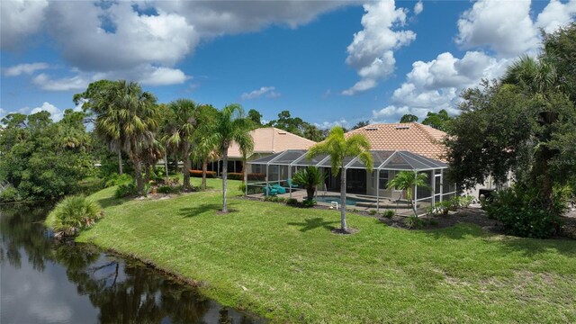 view of property's community with a water view, a swimming pool, and a lawn