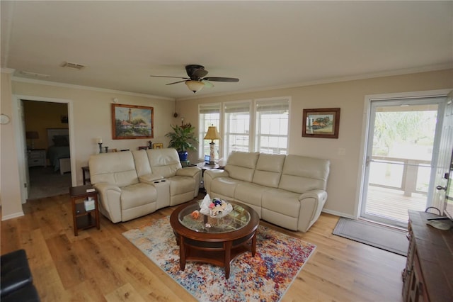 living room featuring light hardwood / wood-style floors, ceiling fan, and crown molding