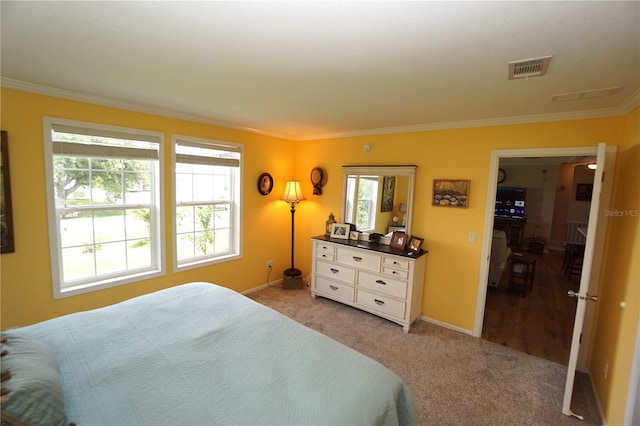 bedroom with light colored carpet and crown molding