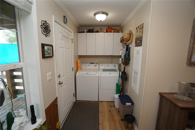 laundry room with cabinets, ornamental molding, a textured ceiling, independent washer and dryer, and light hardwood / wood-style floors