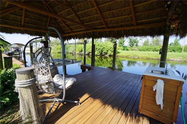 view of dock with a gazebo, sink, and a water view