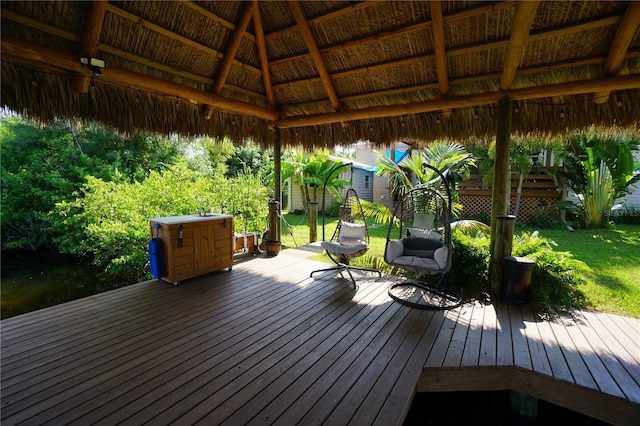 wooden deck with a gazebo and a lawn