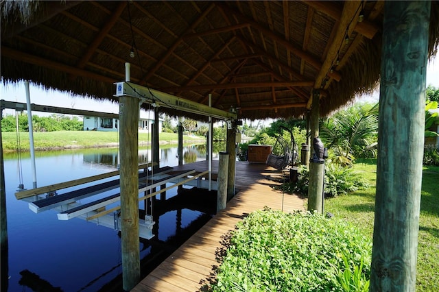 dock area featuring a water view and a lawn