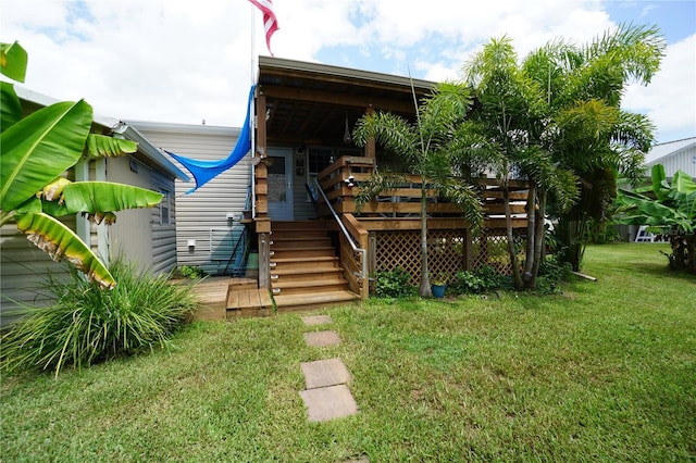 back of property with a lawn and a wooden deck