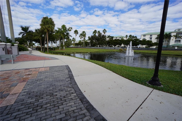 view of community featuring a lawn and a water view