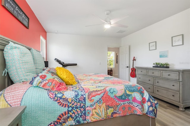 bedroom with light wood-type flooring and ceiling fan