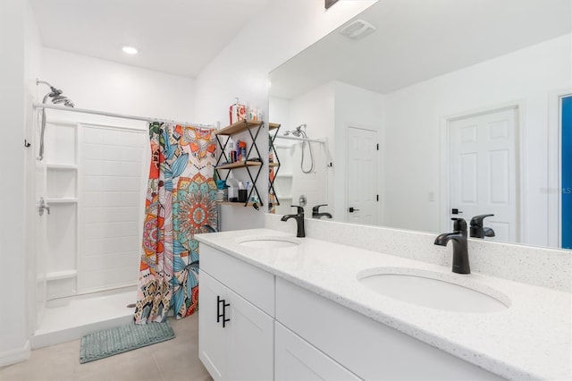 bathroom featuring vanity, tile patterned floors, and walk in shower