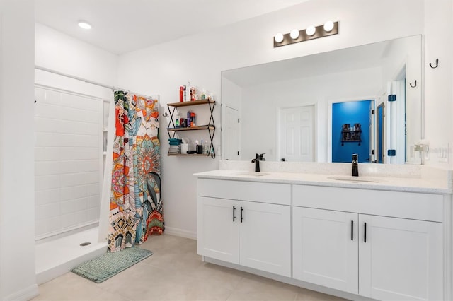 bathroom featuring tile patterned flooring, vanity, and walk in shower