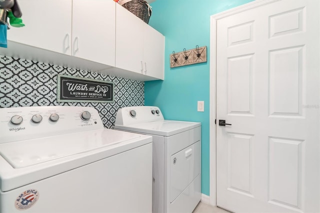 laundry room featuring cabinets and separate washer and dryer