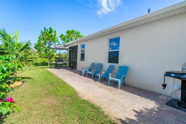 view of yard featuring a patio and a sunroom