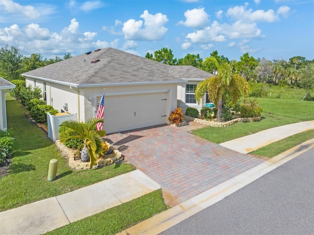 ranch-style home with a garage and a front yard