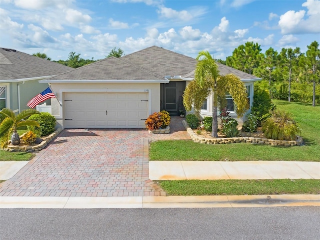 single story home with a front yard and a garage