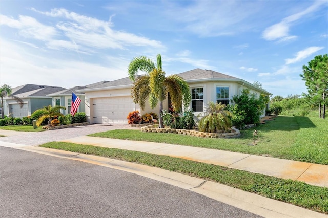 single story home featuring a garage and a front lawn