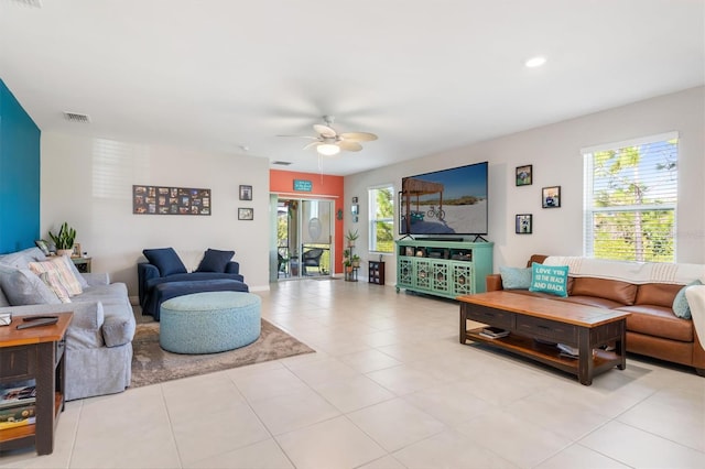 tiled living room with ceiling fan