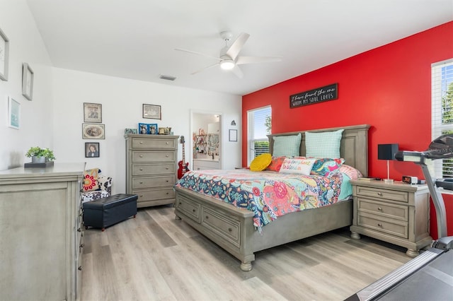 bedroom featuring multiple windows, ceiling fan, and light hardwood / wood-style flooring