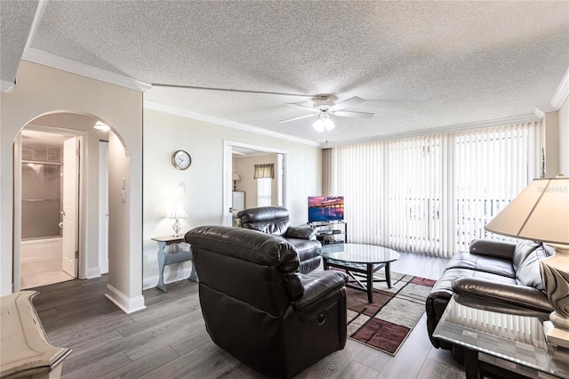 living room with a textured ceiling, ceiling fan, hardwood / wood-style floors, and ornamental molding