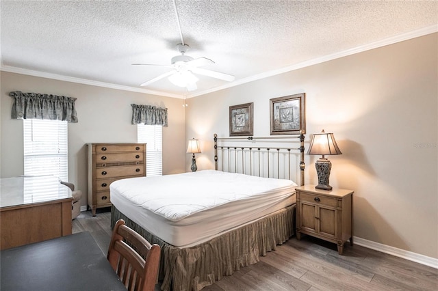 bedroom featuring hardwood / wood-style floors, ceiling fan, a textured ceiling, and multiple windows