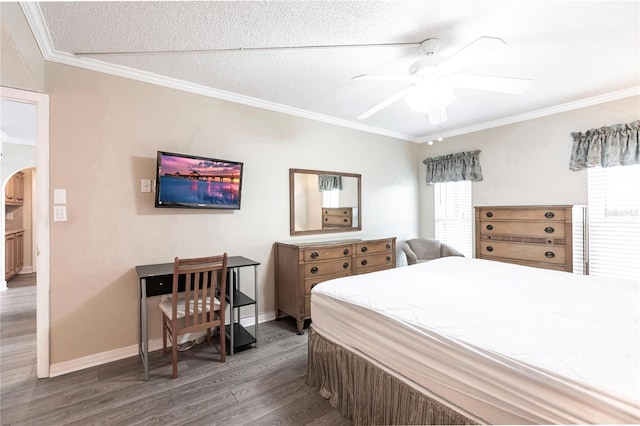 bedroom featuring a textured ceiling, ceiling fan, crown molding, and wood-type flooring