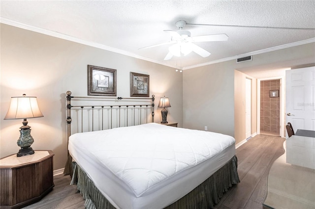 bedroom featuring ceiling fan, light hardwood / wood-style floors, a textured ceiling, and crown molding