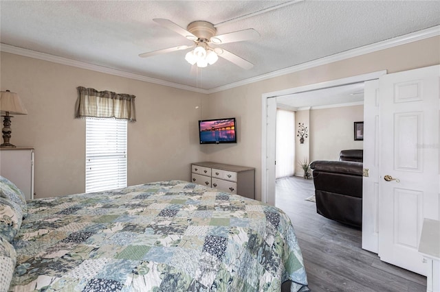 bedroom featuring ceiling fan, dark hardwood / wood-style flooring, a textured ceiling, and crown molding