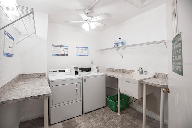 laundry area featuring ceiling fan, washer and dryer, sink, and light tile patterned floors