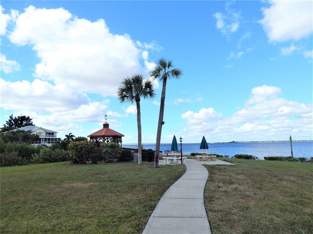 view of home's community with a lawn, a gazebo, and a water view