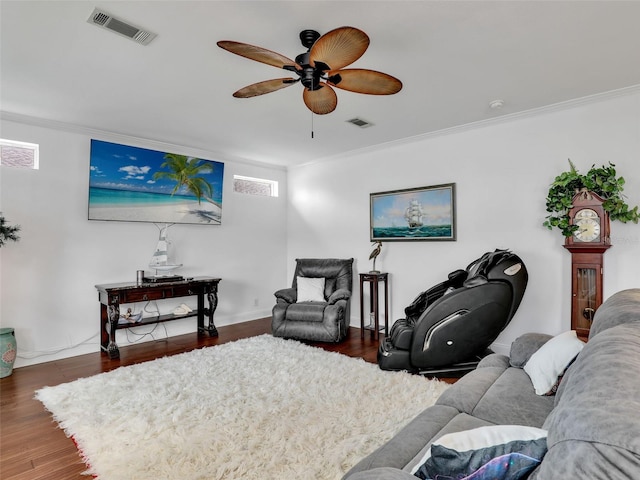 living room featuring ceiling fan, dark hardwood / wood-style flooring, and crown molding