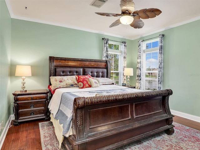 bedroom with ceiling fan, dark hardwood / wood-style flooring, and ornamental molding