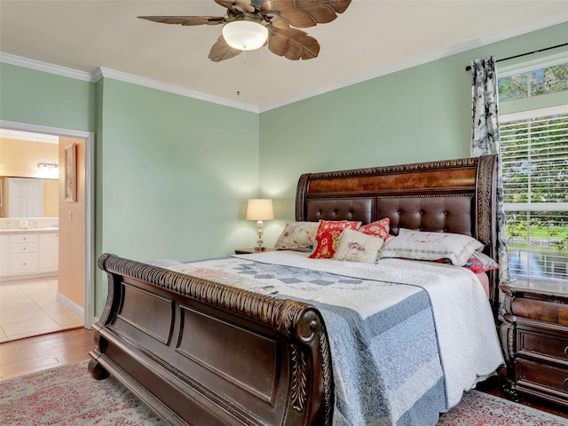 bedroom with ceiling fan, hardwood / wood-style flooring, ornamental molding, and ensuite bath