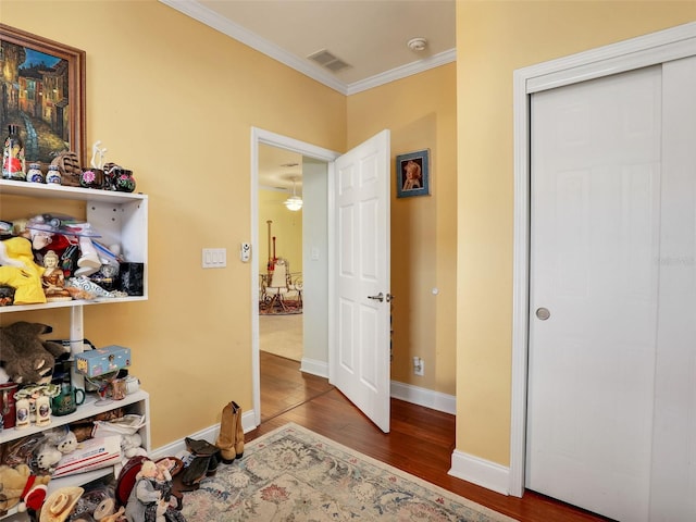 hall featuring crown molding and hardwood / wood-style flooring