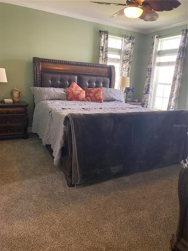 bedroom featuring ornamental molding, carpet floors, and multiple windows