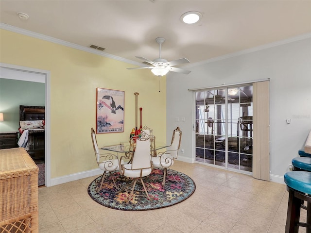 dining space with crown molding, baseboards, a ceiling fan, and visible vents