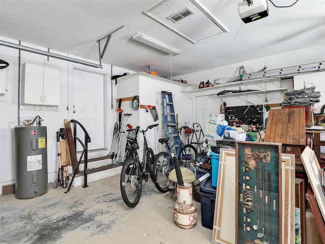 garage featuring visible vents, electric water heater, and a garage door opener