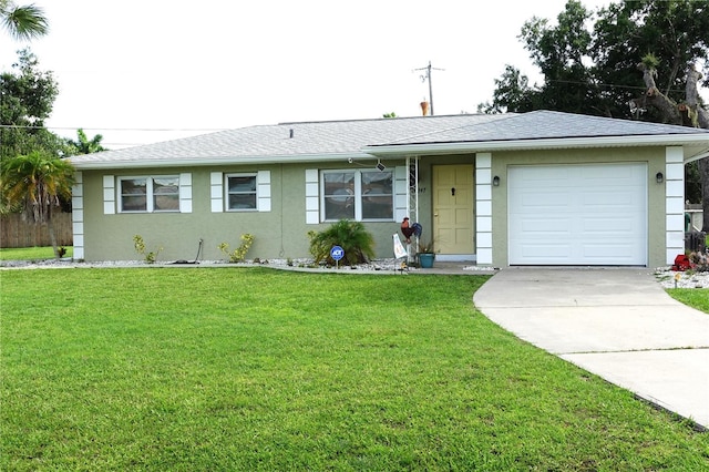 ranch-style house featuring a garage and a front lawn