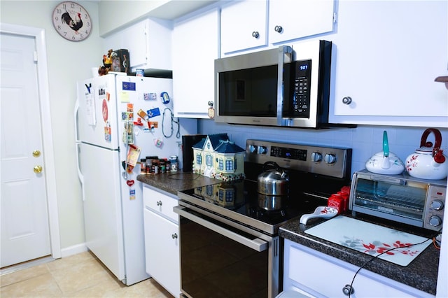 kitchen with tasteful backsplash, white cabinetry, appliances with stainless steel finishes, and light tile patterned flooring