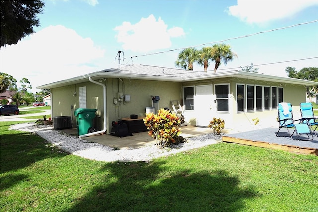 rear view of property featuring a patio area, a lawn, and cooling unit