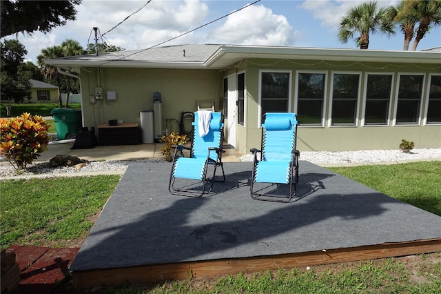 back of house featuring a patio and a yard