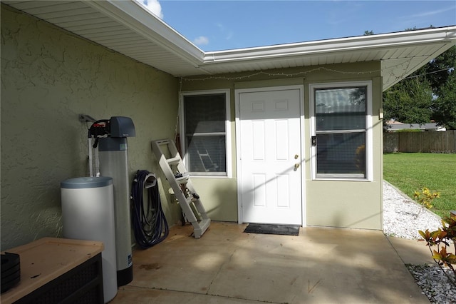 property entrance with a patio area and a yard