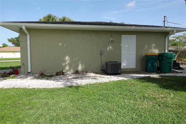 back of house with a lawn and cooling unit