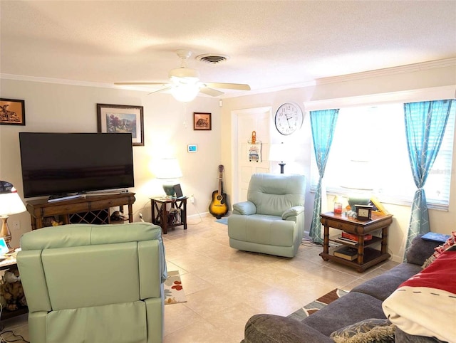 tiled living room featuring ceiling fan, a textured ceiling, and ornamental molding