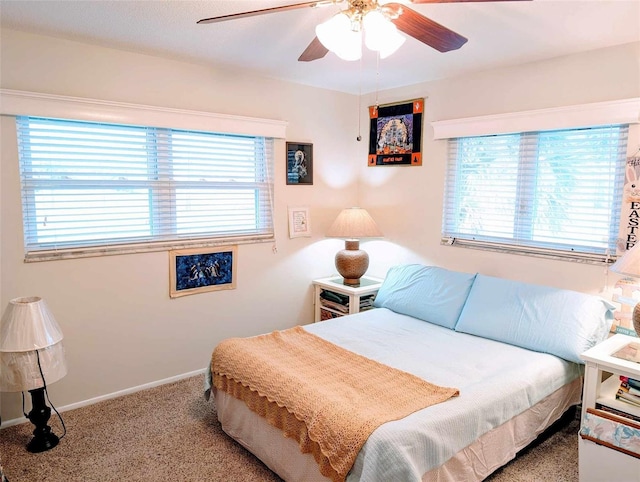 bedroom with ceiling fan and light carpet