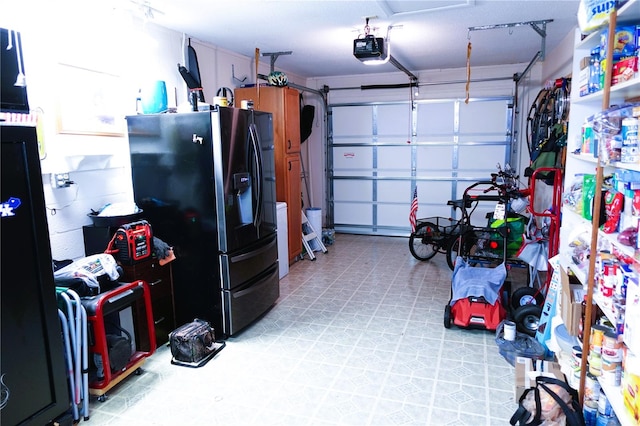 garage featuring a garage door opener and refrigerator with ice dispenser