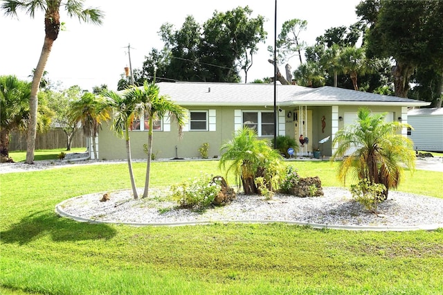 single story home featuring a front lawn