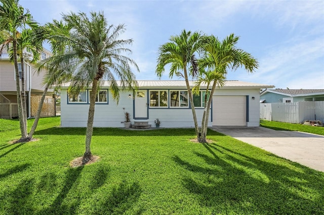 ranch-style home featuring a garage and a front lawn