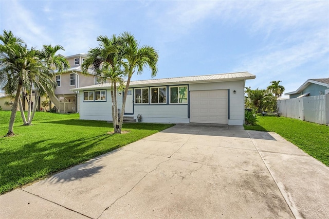 view of front of house featuring a garage and a front lawn