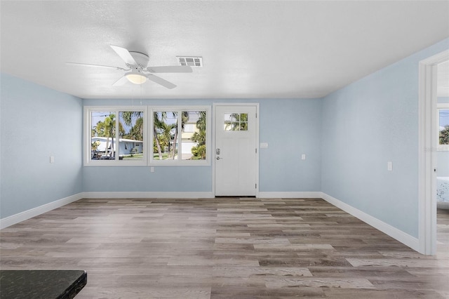 entryway featuring ceiling fan, a textured ceiling, and light wood-type flooring