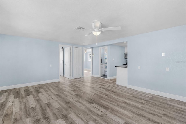 empty room featuring ceiling fan and light hardwood / wood-style floors