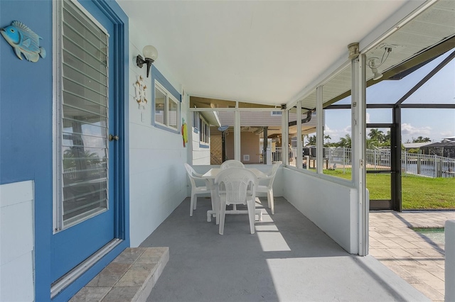 unfurnished sunroom with a water view